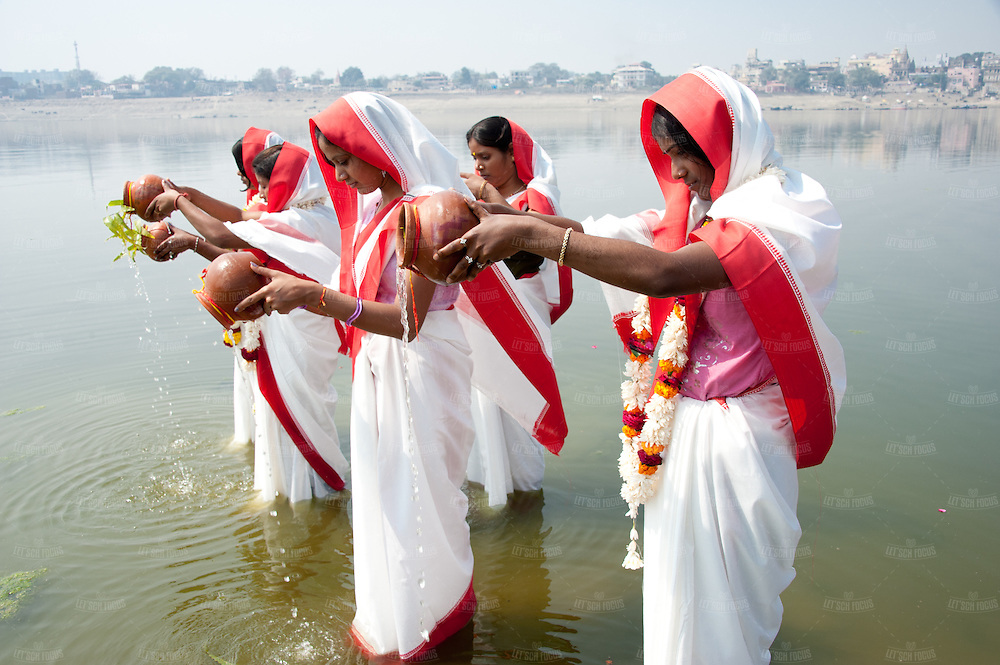 Hindu women praying in the holy water of river Ganges, Varanasi